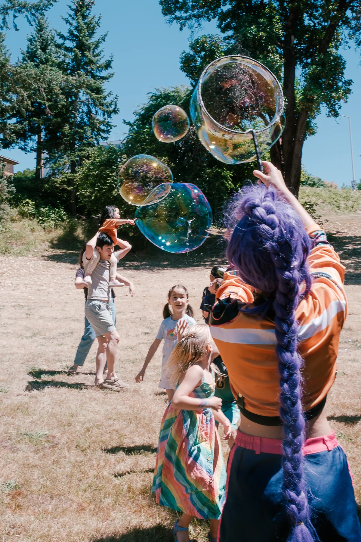 Bubbles floating at a park birthday party