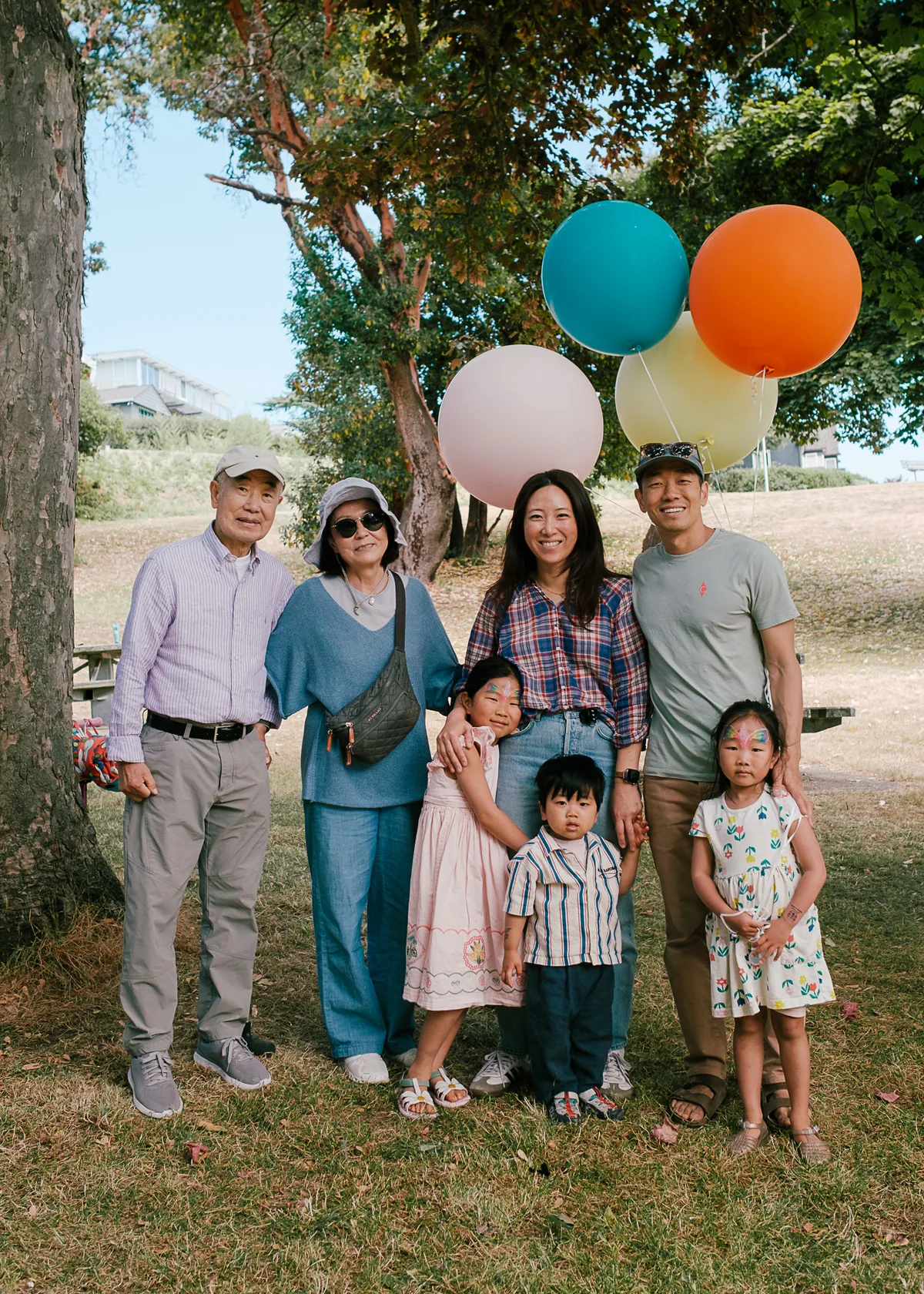Family portrait with balloons in the park
