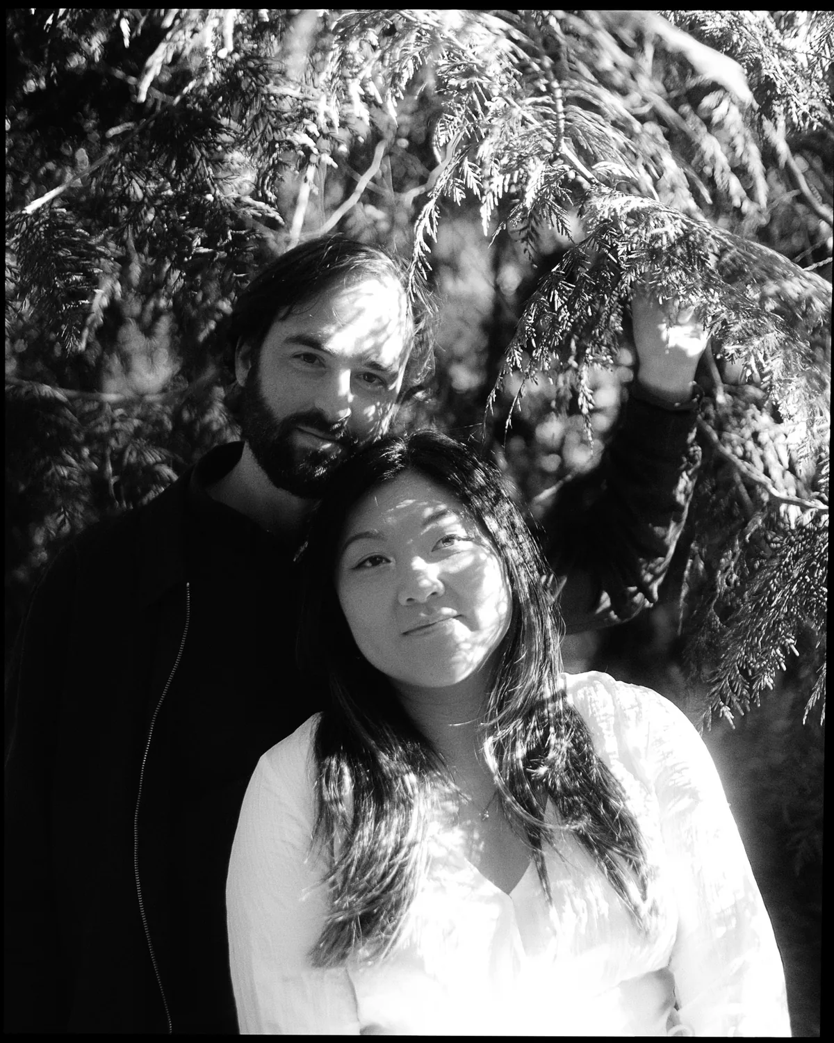 Black and white portrait of a couple in the trees