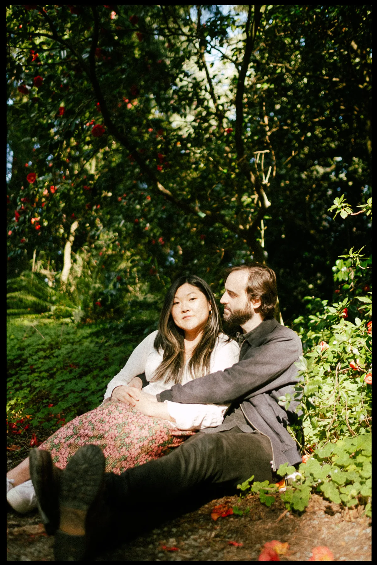 Couple sitting together among flowers